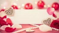 Romantic blank card with wooden hearts, red roses and bokeh lights for Valentine's Day messages, wedding invitations or love letters on pink background.