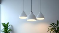 Modern white pendant lamps illuminate minimalist interior with green houseplants against light wall, creating cozy atmosphere for home or office space.