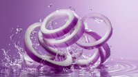 Sliced red onion rings with water splashes on purple background, creating dynamic culinary composition for food photography.