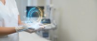Person in white coat holding glowing digital sphere with light trails, representing technology, innovation, and data science concepts for business and digital transformation.
