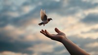Bird taking flight from an outstretched hand against dramatic cloudy sky background, symbolizing freedom, hope, and release.