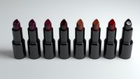 Row of eight black lipstick tubes displaying various shades of red and brown colors arranged in line formation on neutral background, showcasing makeup collection.