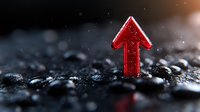 Red glowing arrow pointing upward on dark wet stones background with water drops, dramatic lighting and shallow depth of field for business concept.