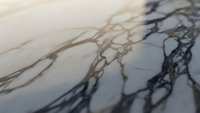 Elegant marble surface with natural veining patterns in cream and gray tones for luxury interior design and architectural applications.