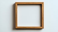 Empty square wooden frame with natural oak texture on light gray wall background, minimalist design element for artwork and photos.
