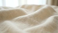 Soft beige linen fabric with natural texture and gentle folds, ideal for home decor, textile design, and interior styling projects.