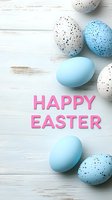 Speckled and blue Easter eggs with pink holiday greeting text on white wooden background. Seasonal spring celebration composition for cards and designs.