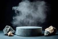 Minimalist stone podium with rising steam surrounded by natural rocks on dark background, dramatic product display setup for luxury presentation.