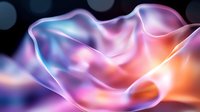 Ethereal flowing silk fabric in purple, pink and orange gradient colors against dark background creates dreamy abstract composition with soft light effects.