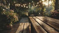 Wooden deck table with string lights creating warm ambiance in garden setting. Outdoor dining and entertainment space with tropical plants and bokeh lighting effects.