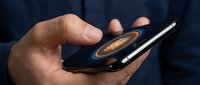 Male hands holding smartphone with glowing Bitcoin symbol on screen, digital cryptocurrency concept, blockchain technology and mobile finance.
