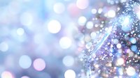 Sparkling particles and bokeh lights create an elegant, festive atmosphere with soft blue, pink, and white tones flowing across the frame.