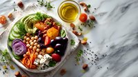 Colorful healthy Buddha bowl with avocado, chickpeas, vegetables, nuts and olive oil on marble background for nutritious meal planning and diet.
