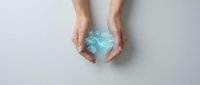 Hands protecting glowing blue digital brain with neural network connections representing artificial intelligence and mind protection concept.