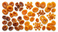 Dried apricots in various cuts and sizes arranged on white background, ready for food packaging, recipe blogs, nutritional content, and culinary design projects.