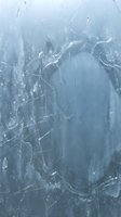 Cracked broken glass surface with spider web pattern and blue tinted background creating dramatic shattered effect for design projects.