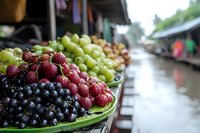 Fresh organic grapes and berries displayed at local farmers market stall. Healthy eating, natural produce, agricultural commerce concept for food blogs.