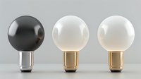 Minimalist light bulbs in black and white with metallic bases arranged in row on neutral background, modern design elements for interior lighting solutions.