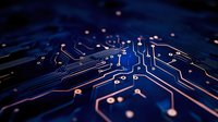 Circuit board macro with glowing blue and orange electronic pathways and connections on dark background, modern technology concept for computing and AI development.