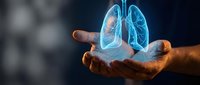 Human hands holding glowing holographic lungs with highlighted respiratory system for medical education and healthcare technology concepts.