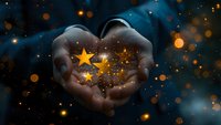 Magical cupped hands holding glowing golden stars against dark blue mystical background with bokeh lights, perfect for spiritual and inspirational designs.