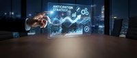 Businessman hand touching digital holographic display showing anticipation strategy with upward trending graphs and financial charts in modern office environment.