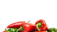 Fresh red and green chili peppers isolated on white background for culinary cooking spice ingredient design projects and healthy food concepts.