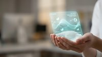 Hands holding futuristic holographic interface with glowing data visualization and digital elements floating above palm in modern technology concept.