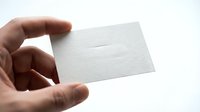 Hand holding blank white business card mockup on clean background for branding and corporate identity design projects.