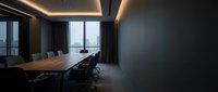 Modern executive conference room with wooden table, ergonomic chairs, floor-to-ceiling windows, ambient ceiling lighting, and city skyline view. Corporate meeting space for business presentations.
