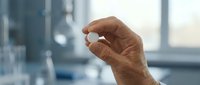 Mature adult male hand making small gesture against blurred office window background, suitable for business communication and corporate messaging.