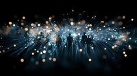 Glowing blue light rays burst through darkness with scattered golden bokeh effects creating magical atmosphere for festive or celebration backgrounds.