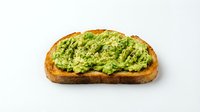 Avocado toast on artisan bread slice with mashed green spread and herbs isolated on white background for healthy breakfast menu design.