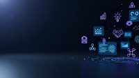Digital technology icons floating above laptop screen in dark blue futuristic business environment for corporate presentations and tech solutions.