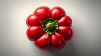 Fresh ripe red heirloom tomato with distinctive flower-like shape viewed from above on gray background, dramatic lighting highlights unique form and texture.