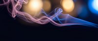 Abstract purple and blue smoke waves flowing gracefully against dark background with warm golden bokeh lights creating elegant atmospheric effect.