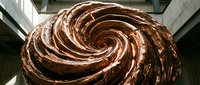 Overhead view of rich chocolate frosting swirled in spiral pattern, ideal for bakery, dessert, and confectionery design projects.