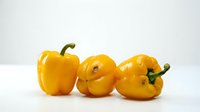 Yellow bell peppers isolated on white background, fresh produce for cooking, healthy food ingredient, culinary use.