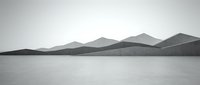 Serene monochrome landscape featuring distant mountains reflected in calm water, conveying tranquility and minimalist aesthetics for meditation and nature-themed designs.