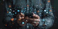 Digital technology concept with hands holding smartphone surrounded by floating social media and tech icons, perfect for business communication and mobile apps.