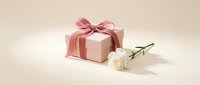 Pink gift box with satin ribbon bow and white carnation flower on beige background, elegant present for wedding, birthday or Mothers Day.