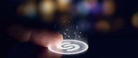Businessman finger touching glowing digital loading icon with sparkling particles on dark blurred background for technology and progress concepts.