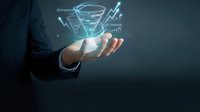 Business professional displaying holographic data visualization with charts and graphs in open palm for digital marketing presentations.