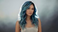 Young Asian woman with vibrant blue-green ombre hair and wavy hairstyle wearing beige top against soft blurred background for beauty and fashion concepts.