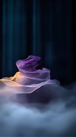 Abstract flowing fabric waves in purple and orange gradient colors against dark blue background creating ethereal motion effect for modern design projects.
