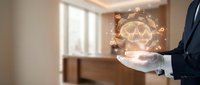 Businessman holding digital crown hologram symbol representing leadership, success and achievement in modern office environment for business concepts.