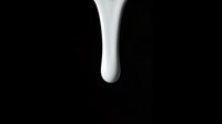 White liquid dripping or flowing downward against a dark background, isolated and ready for design use in advertising, cosmetics, skincare, dairy, and beverage marketing materials.