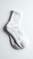 Pair of white ribbed cotton crew socks isolated on white background, folded neatly for retail, fashion, or sportswear product presentation.