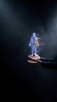 Futuristic holographic human body projection floating above businessman hands with digital data streams and glowing light effects on dark background.