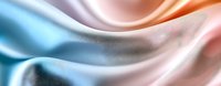 Smooth flowing silk fabric in pastel blue and peach colors creates gentle waves and folds with soft gradient transitions and elegant satin texture.